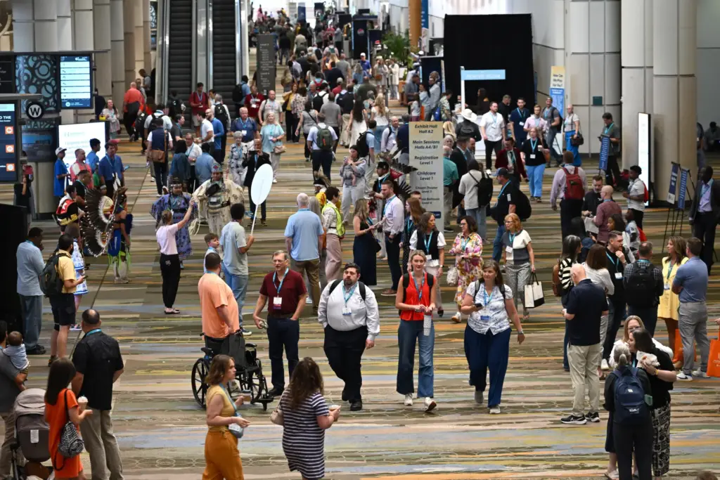 Attendees walk through the Orange County Convention Center during the...