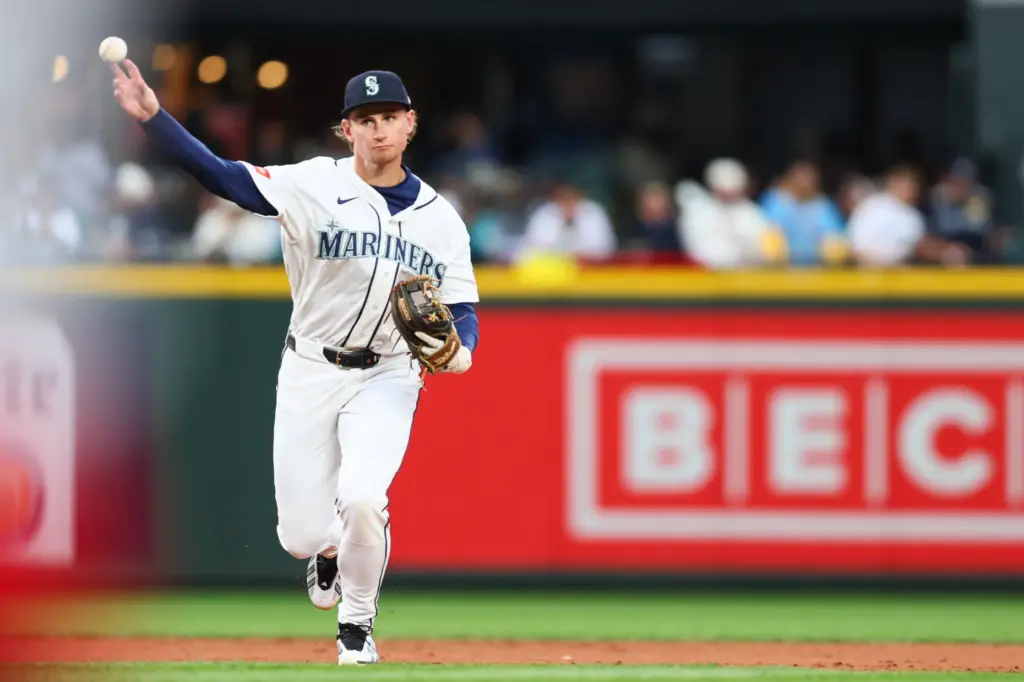 Seattle Mariners infielder Colt Emerson throws to first base during...