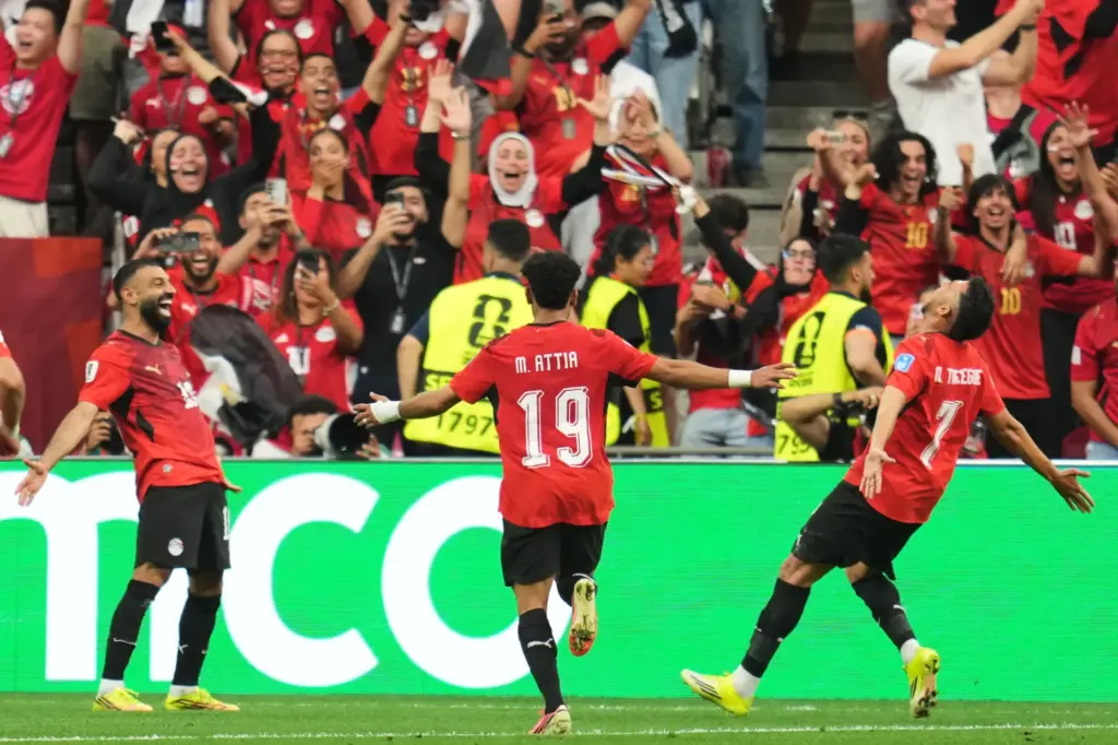 Egypt’s Trezeguet (7) celebrates with Mohamed Salah (10) and Marawan...