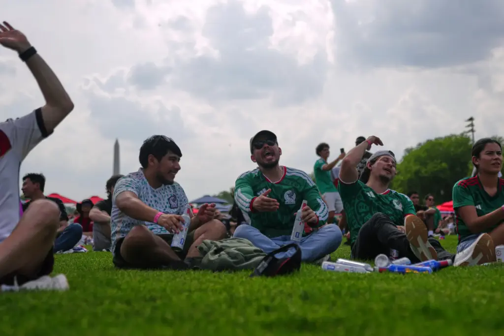 Fans watch the first match of the World Cup between...