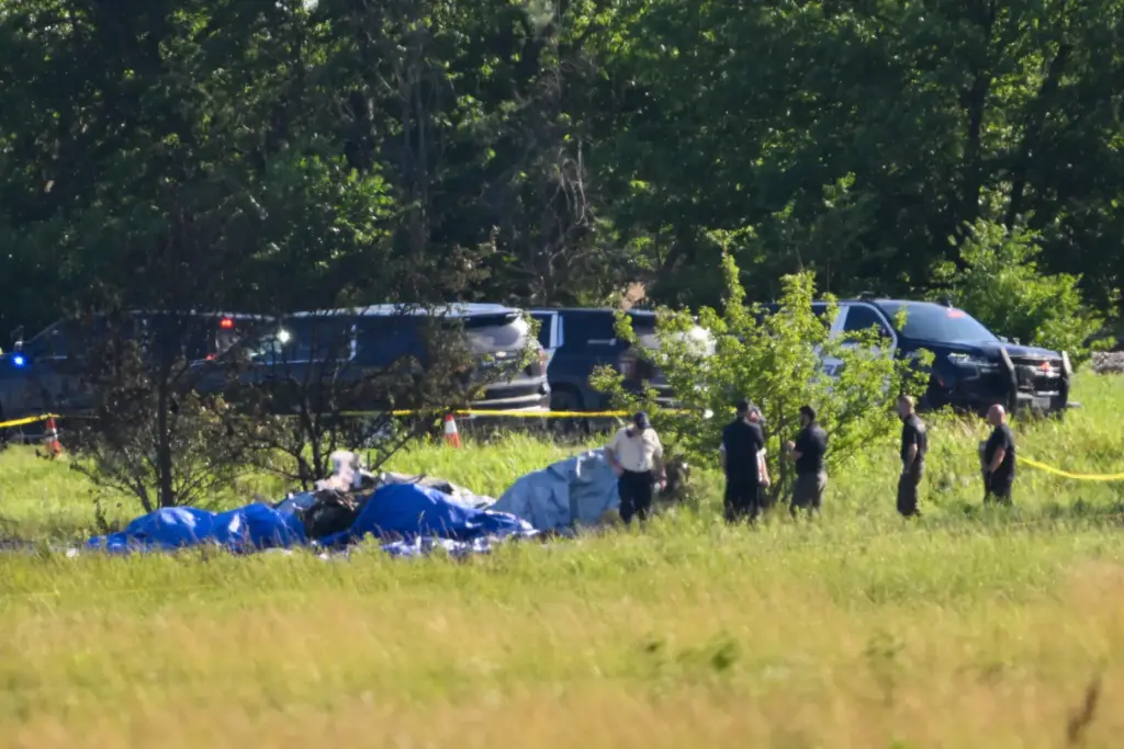 Emergency personnel investigate the site of a plane crash in Butler, Missouri.