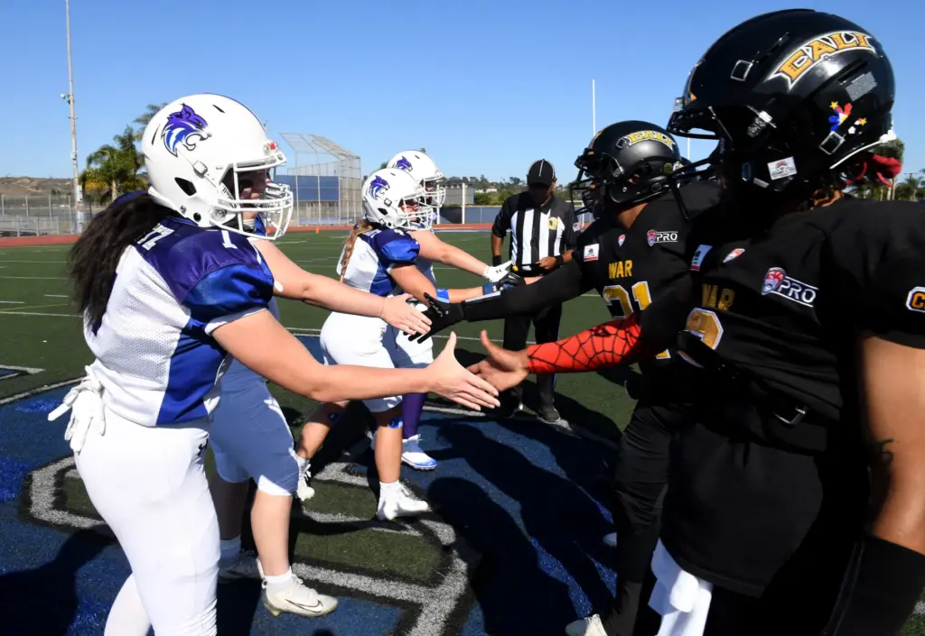 Team captains meet for the coin toss before a CaliWar...
