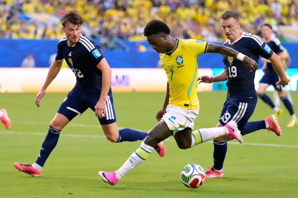 Brazil’s Vinicius Junior (7) battles for the ball with with...