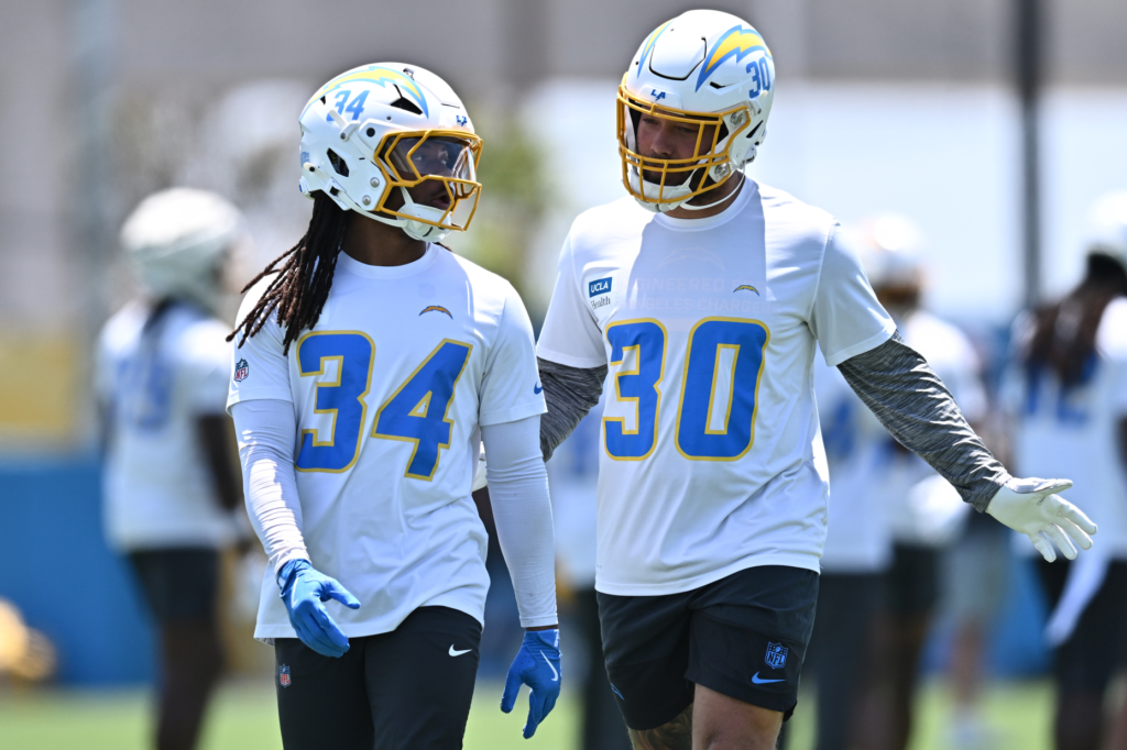 Chargers running backs Keaton Mitchell (34) and Kimani Vidal (30)...