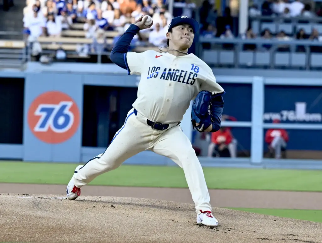 Starting pitcher Yoshinobu Yamamoto #18 of the Dodgers throws to...