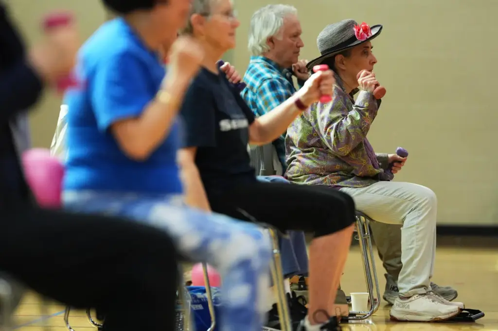 Eileen Weintraub uses light weights during a class for older adults.