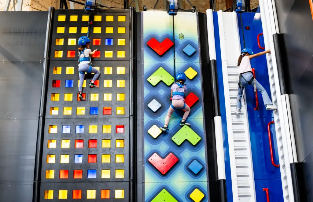 Campers climb three walls in Sender City during Rock Climbing...