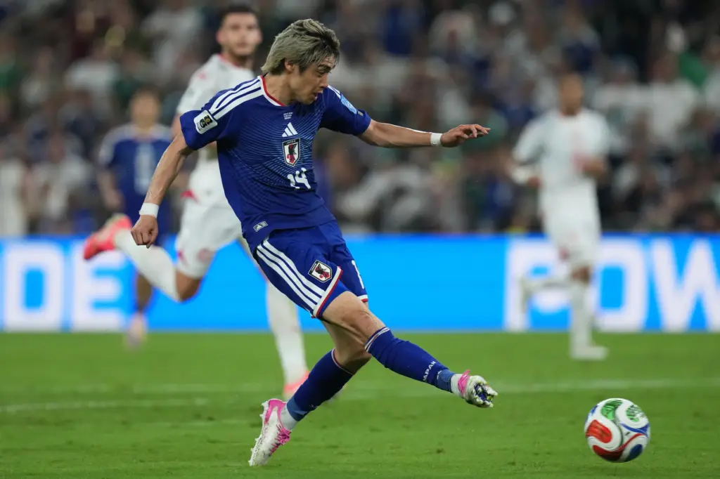 Japan’s Junya Ito scores his side’s third goal against Tunisia...