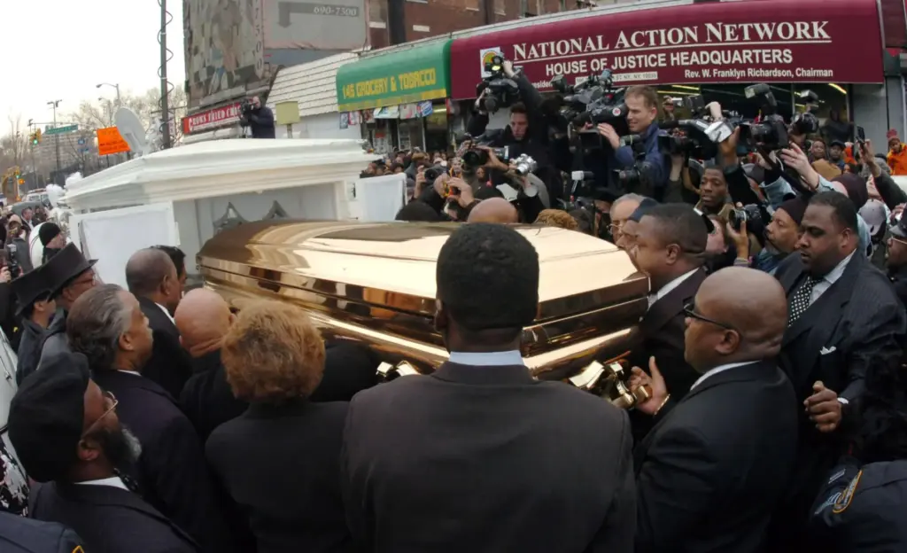 The casket of singer James Brown is placed in a horse drawn carriage.