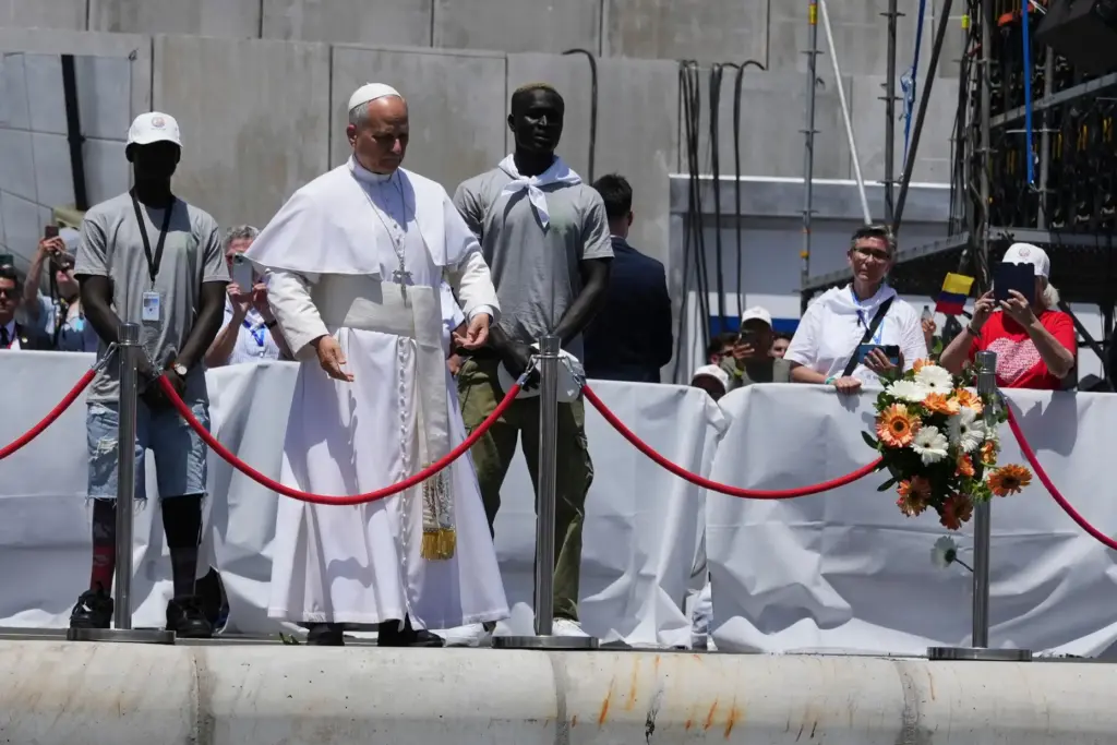 Pope Leo XIV throws a bouquet of flowers into the...
