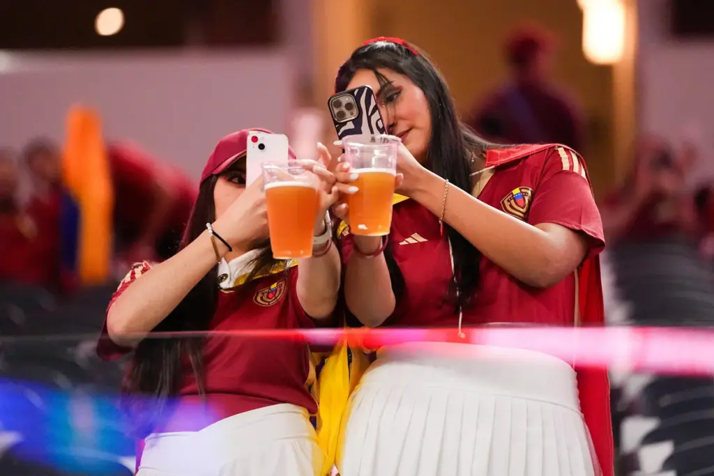 Venezuela fans take photos of their beers before a Copa America quarterfinal.
