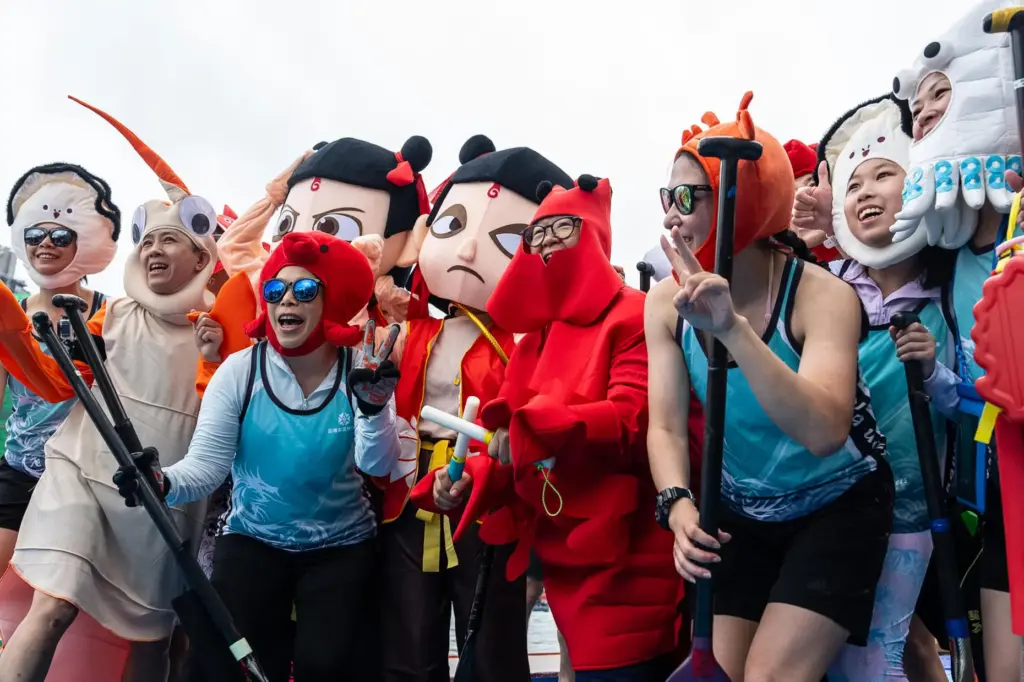 Competitors in costumes pose for photographs before the Aberdeen Dragon...