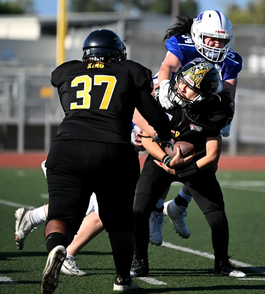 Cali War quarterback Tania Yareli Guzman is under pressure against...
