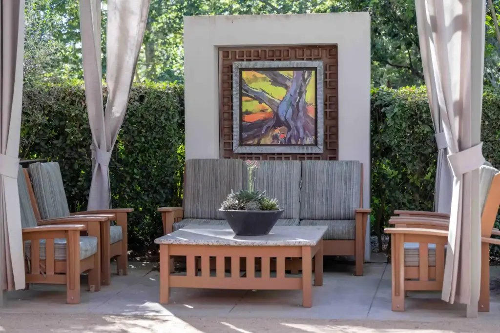 An acrylic painting by artist Laura Green decorates a sitting...