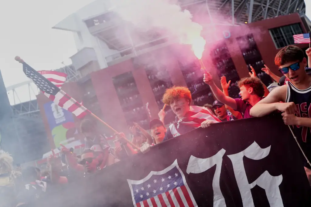 A group of United States fans arrive outside the stadium...