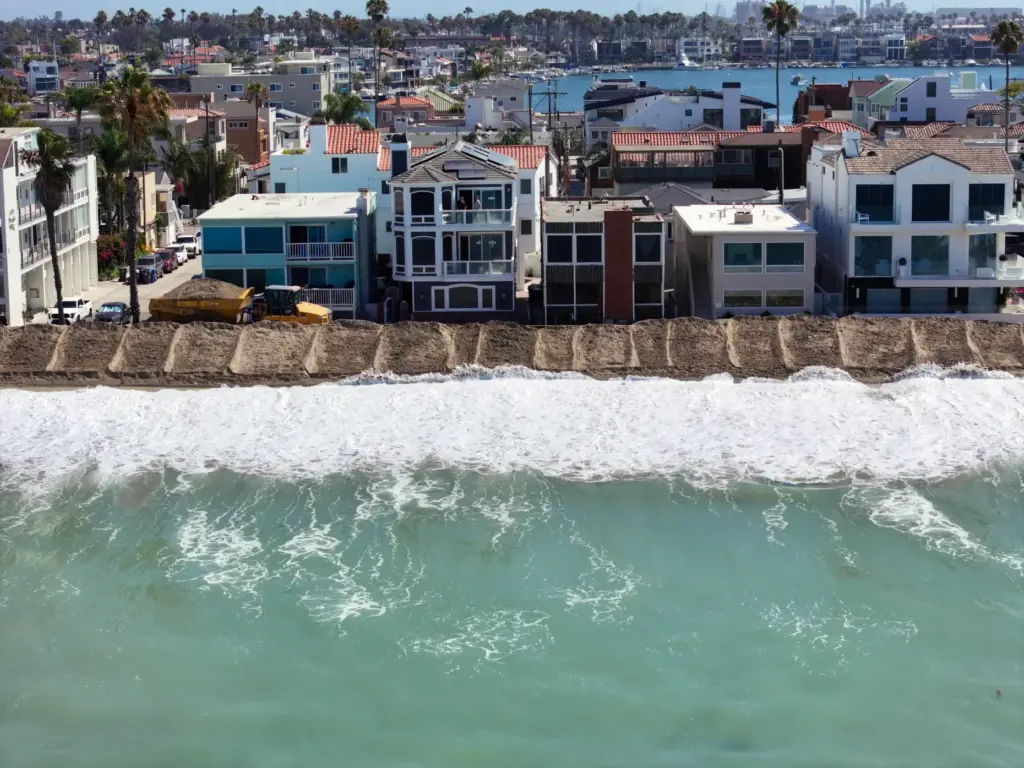 A berm is built in the sand to protect homes...