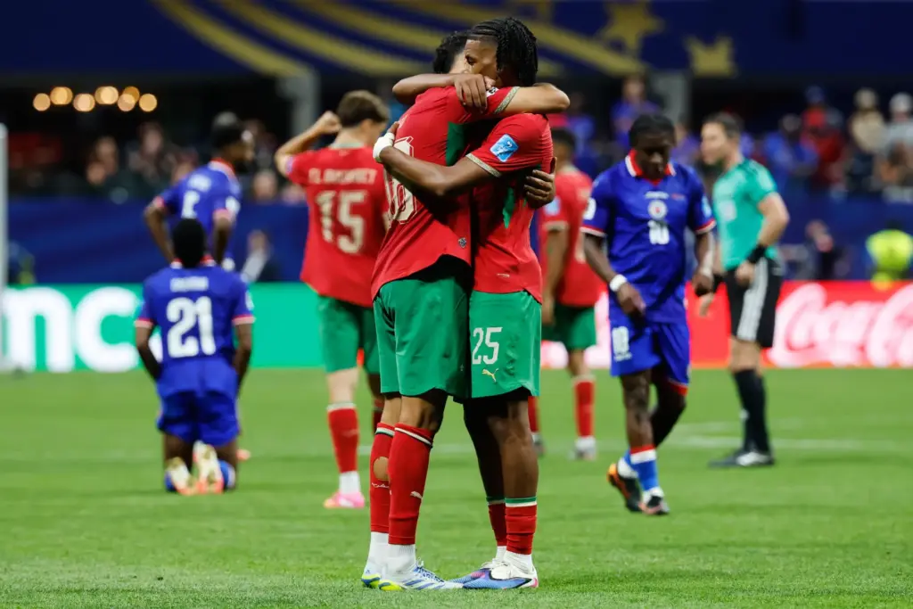 Morocco’s Chadi Riad (18) and Redouane Halhal (25) celebrate the...