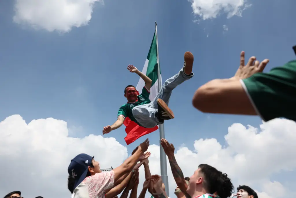 A Mexico fan is tossed into the air in celebration...