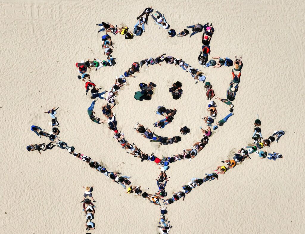 Over 1,000 kids form a giant artwork in the sand...