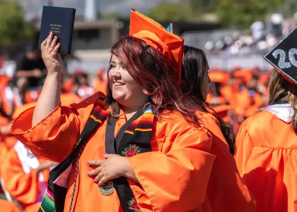 Eliana Martinez shows off her new diploma during Orange High...