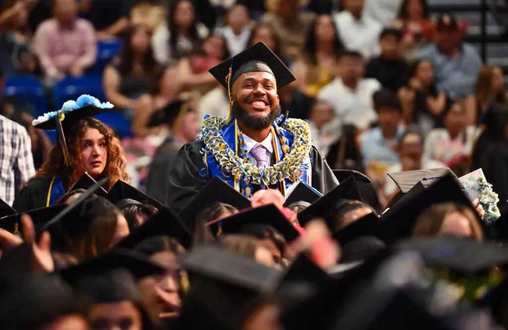 Graduate Xavier Hunt smiles to the crowd during the commencement...