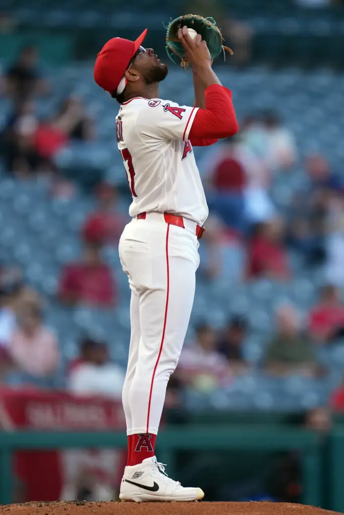 Angels starting pitcher Walbert Urena looks skyward before pitching during...