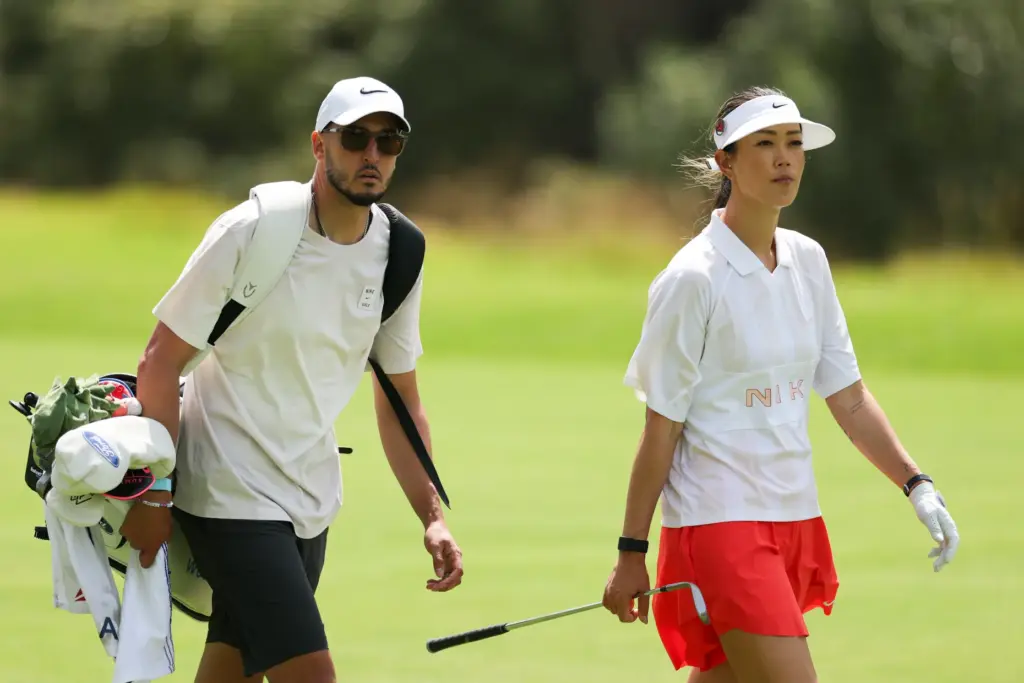 Michelle Wie West and caddie and husband Jonnie West play...