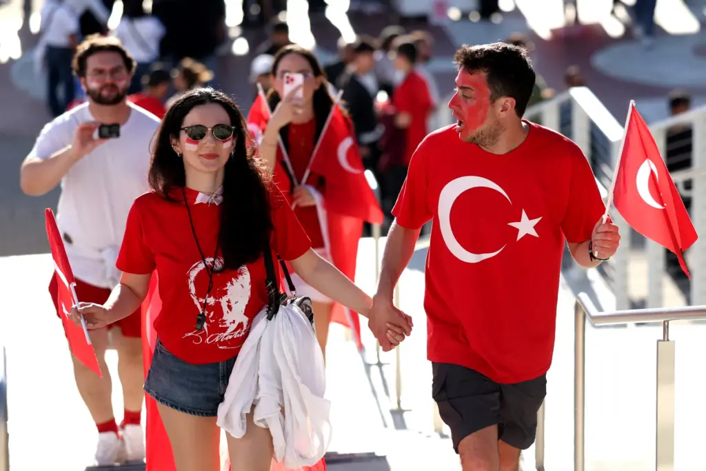 Fans arrive for a FIFA World Cup match between Turkey...