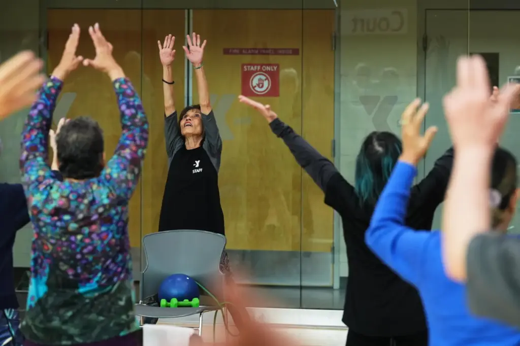 Instructor Bengie Santos, 72, leads a class for older adults.