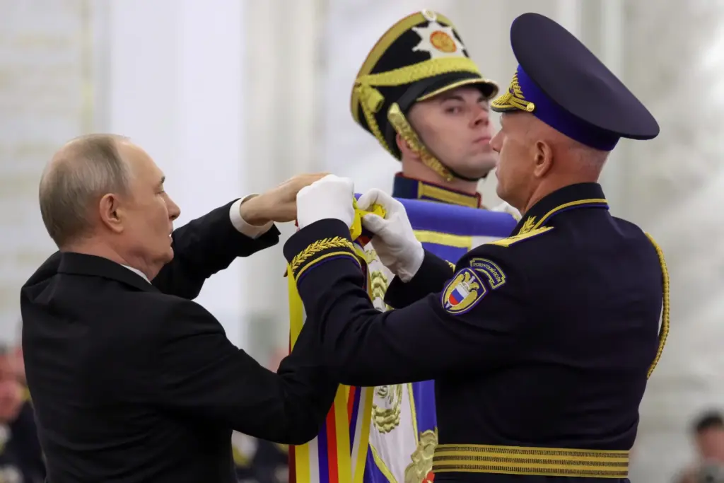 Russian President Vladimir Putin and Commander of the Presidential Regiment Maj. Gen. Mikhail Suraikin.