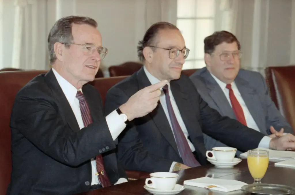 President George Bush gestures while meeting with economic advisers.