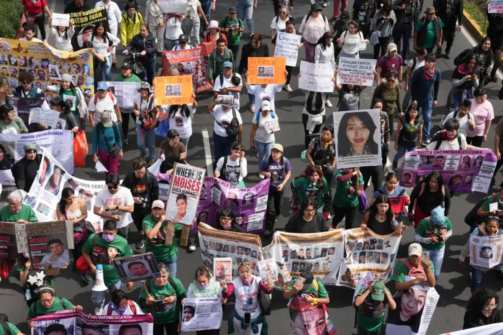 Relatives of Mexico’s disappeared march before the opening match of...