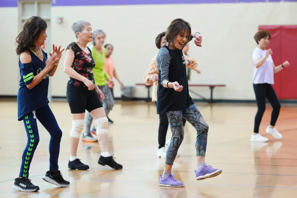 Instructor Bengie Santos, 72, leads a class for older adults.