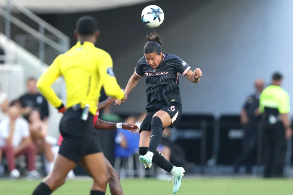 Angel City FC defender Emily Sams heads the ball against...