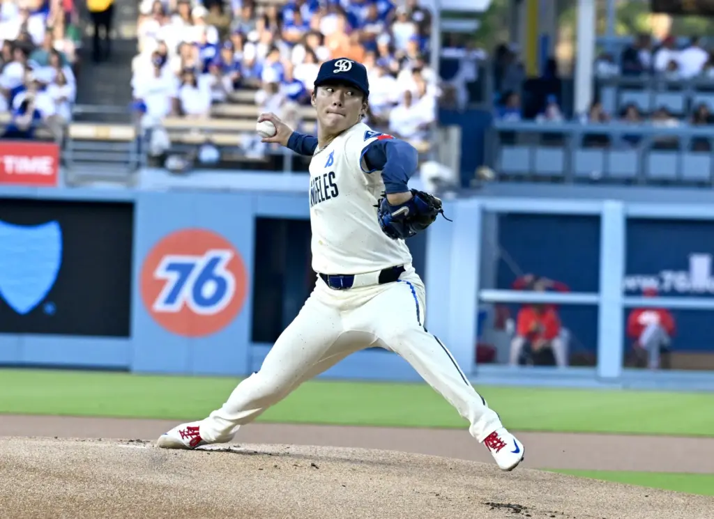 Starting pitcher Yoshinobu Yamamoto #18 of the Dodgers throws to...