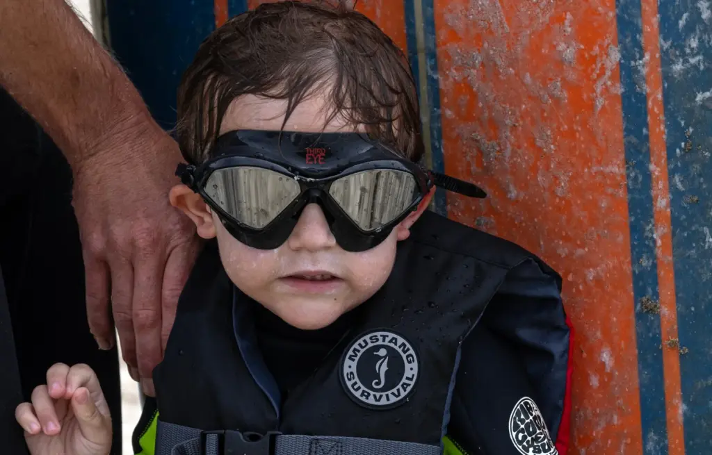 Three-year-old Ford Uytengsu finishes his surfing session during the 30th...