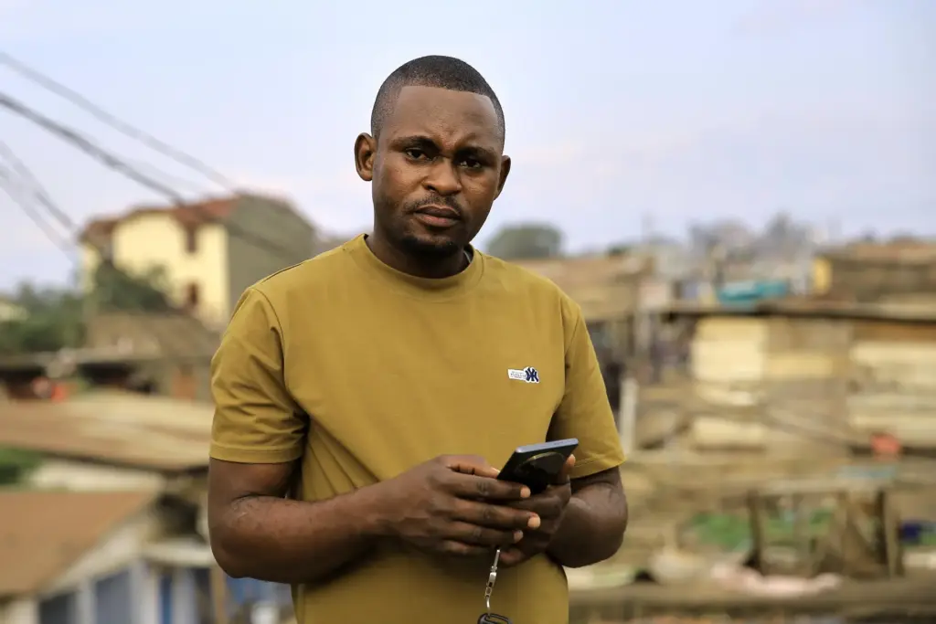 Vianney Kambale Kombi, an Ebola survivor, poses for a photo...