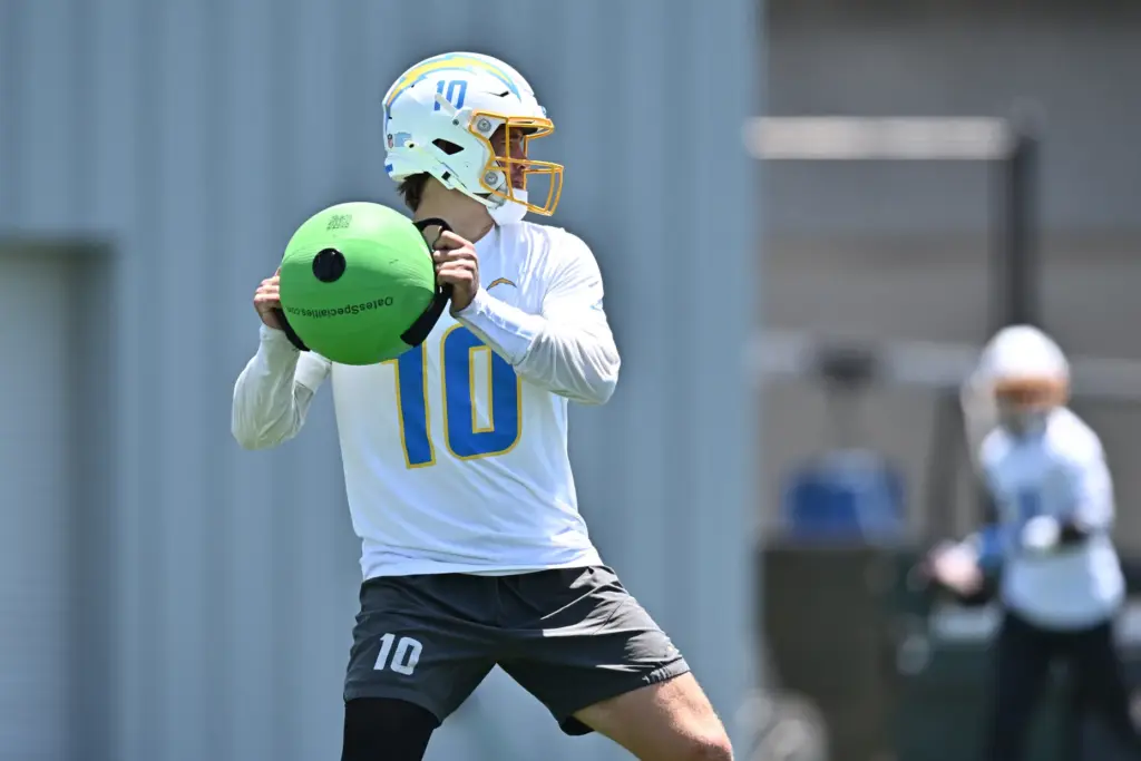 Chargers quarterback Justin Herbert runs a drill during the NFL...