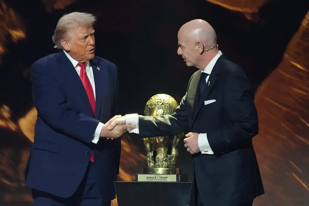 President Donald Trump shakes hands with FIFA President Gianni Infantino.