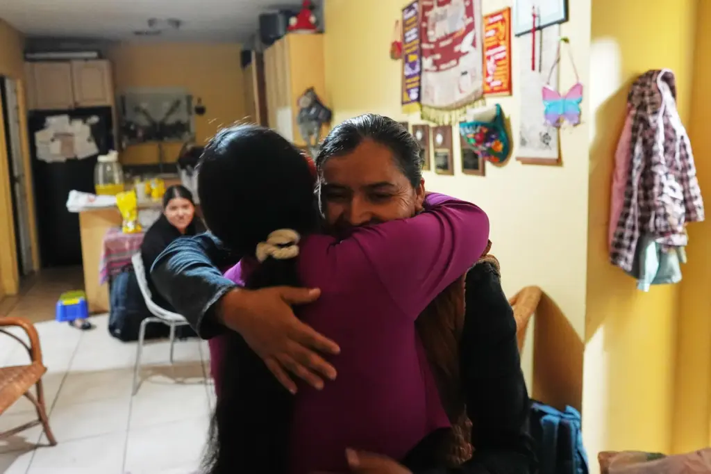 Mirsy Maricela Alva Lopez, right, embraces a relative as she...