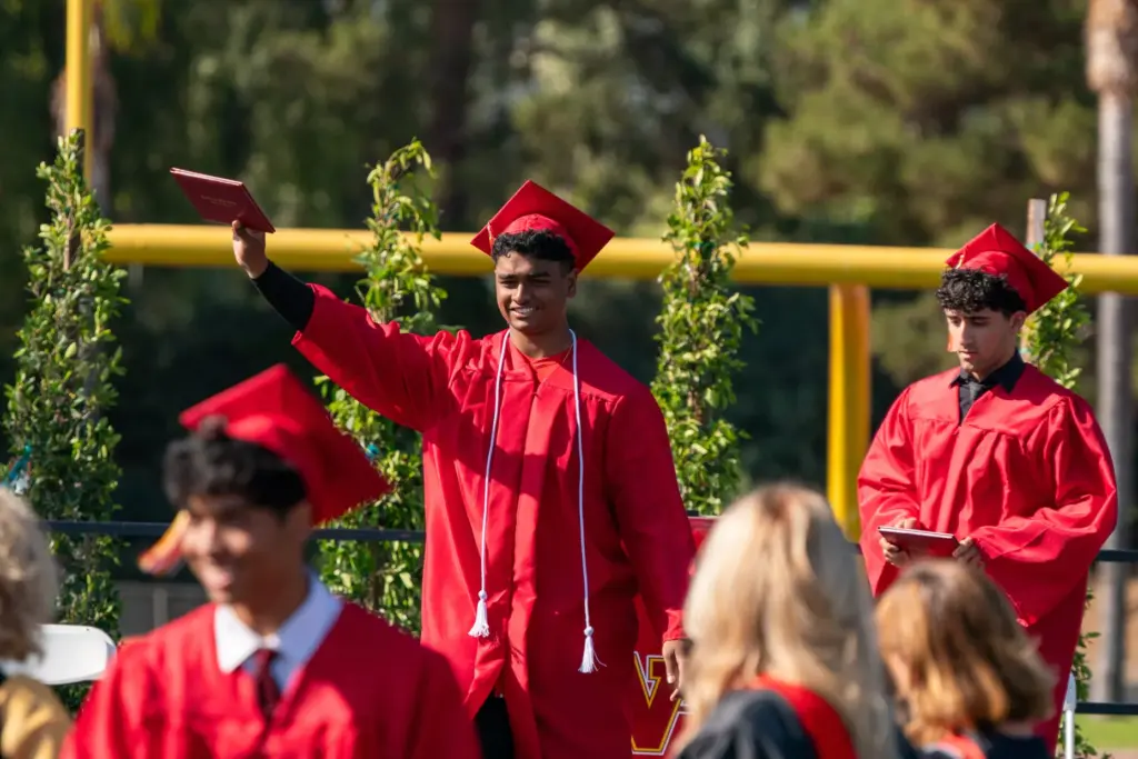 A graduate raises his diploma during the Woodbridge High School...