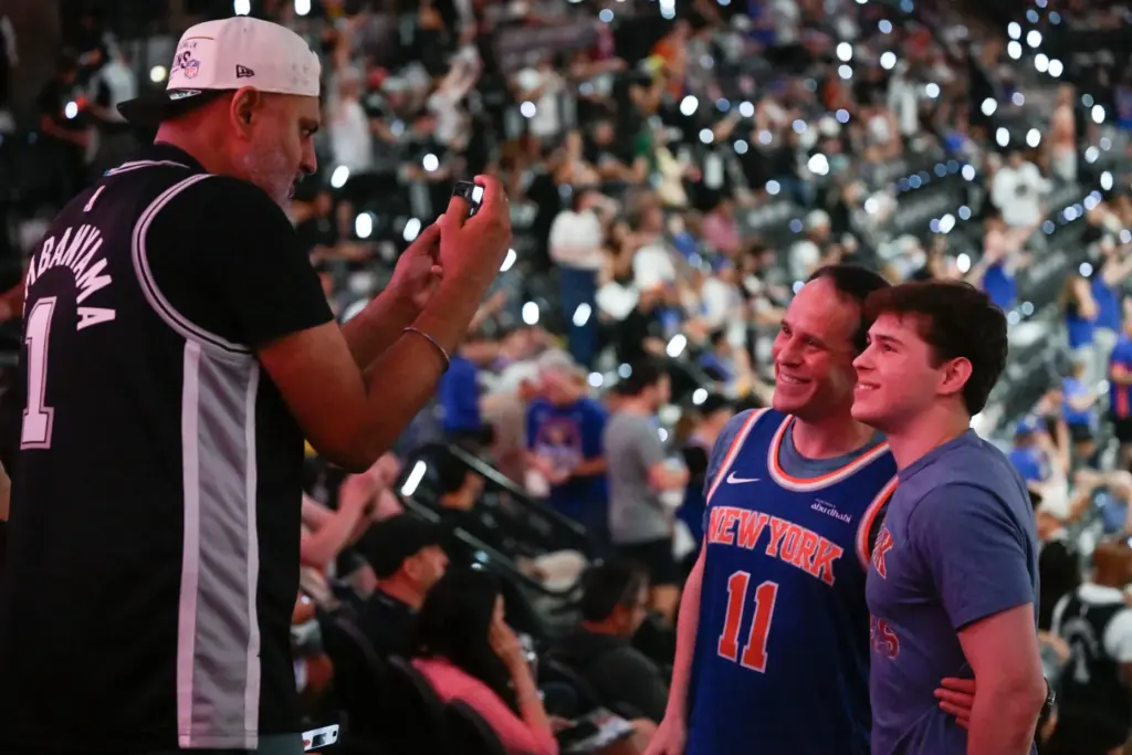 A San Antonio Spurs fan takes a photo for New...