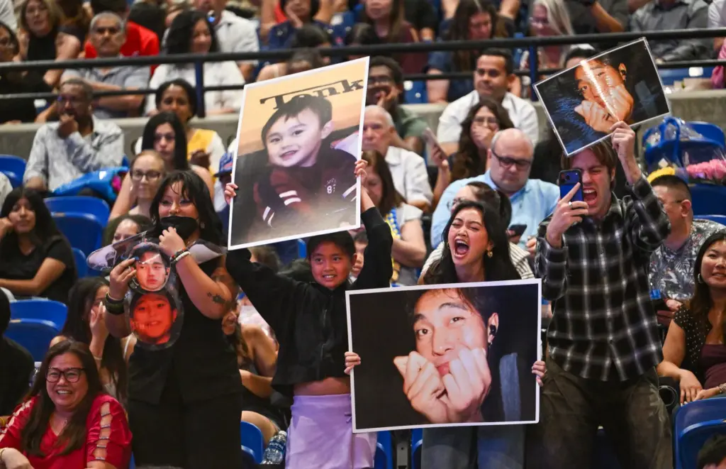 Friends and family cheer for a graduate during the commencement...