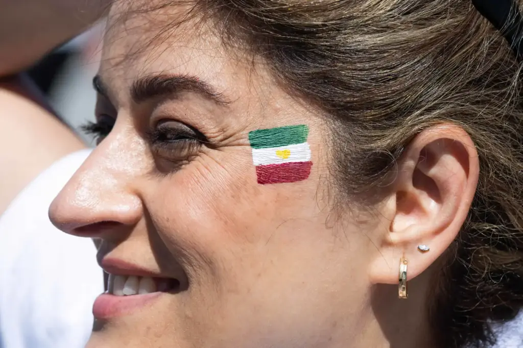 Afsaneh Salari smiles after having her face painted outside SoFi...