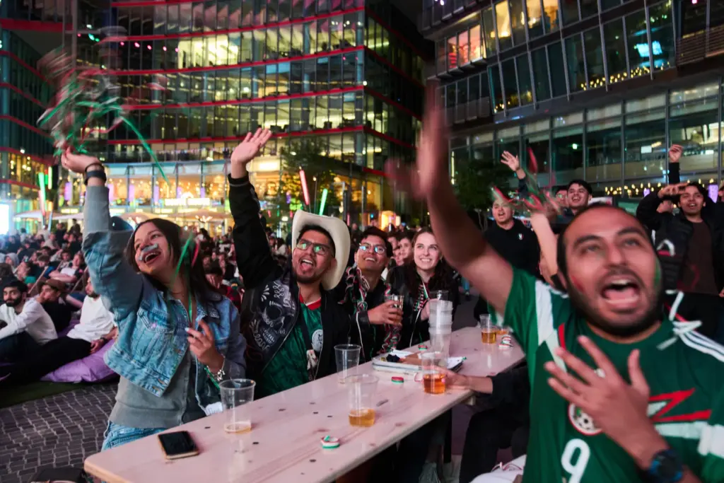 Fans react as they watch a broadcast of the World...