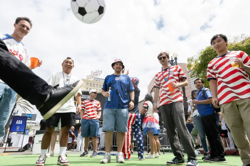 U.S.A. soccer fans kick an inflatable soccer ball during a...