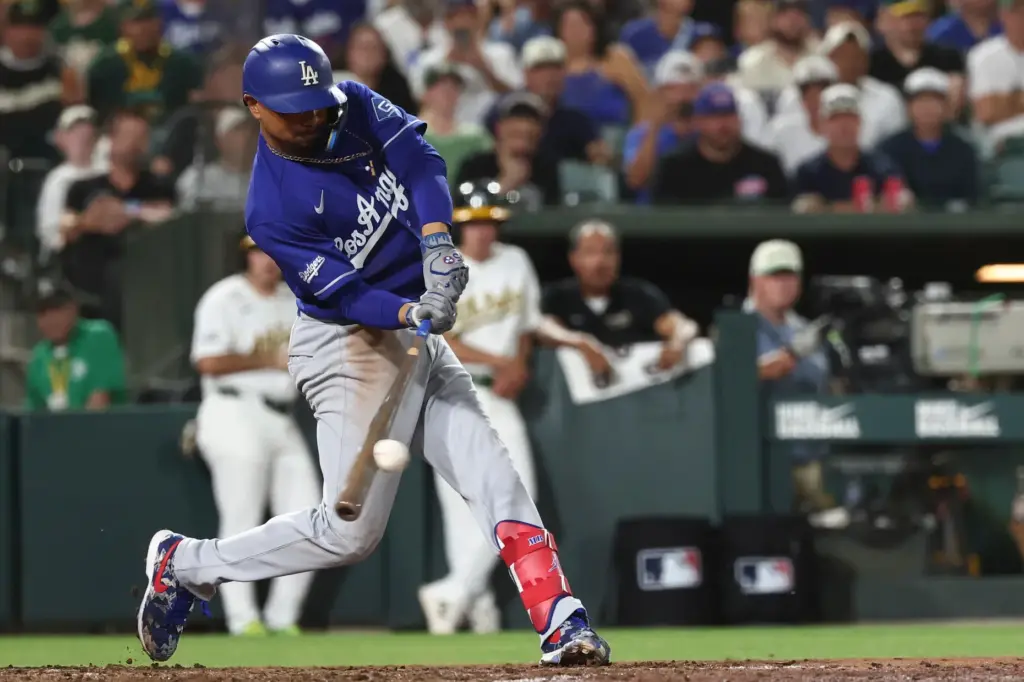The Dodgers’ Mookie Betts hits a single during the eighth...