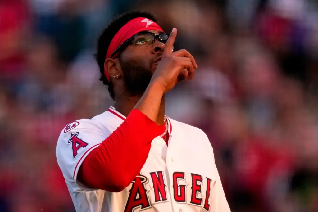 Angels starting pitcher Walbert Urena gestures as he walks off...