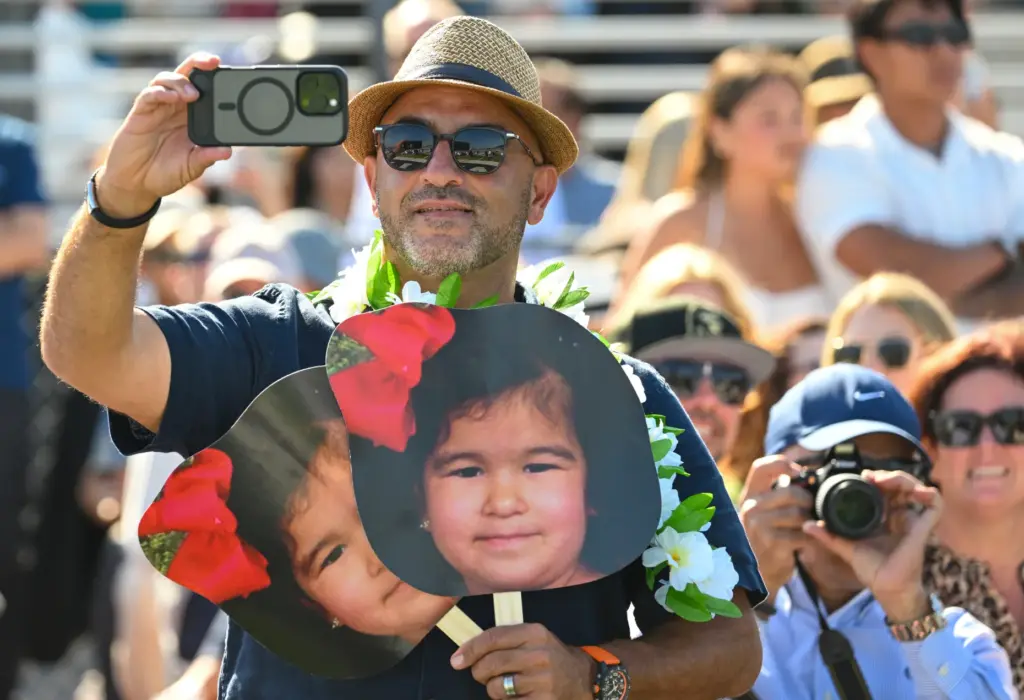Tamer Youssef, takes a picture of graduate Malak Youssef during...