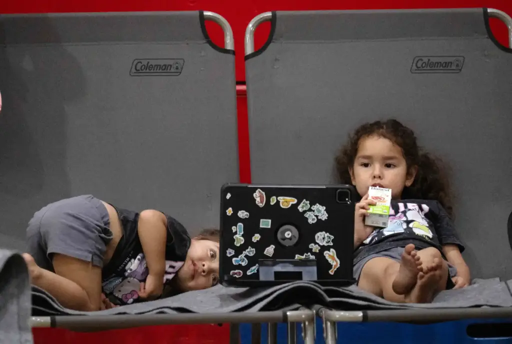 Oscar Maye keeps his daughters, Lucia, 2, left and Violetta,...